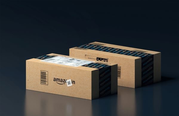 Two amazon boxes ready for delivery set against a black background.