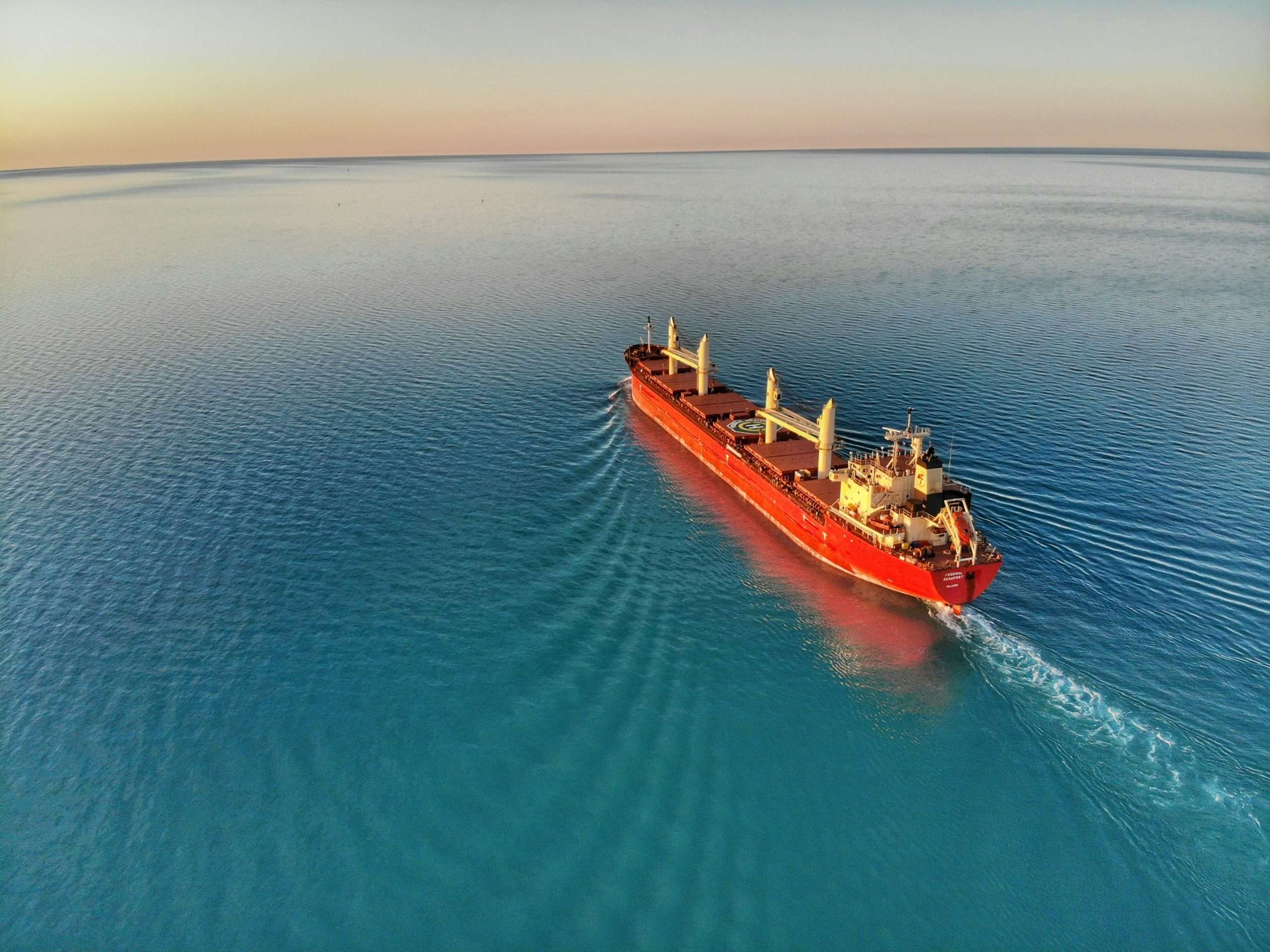 A container ship passing across the sea.