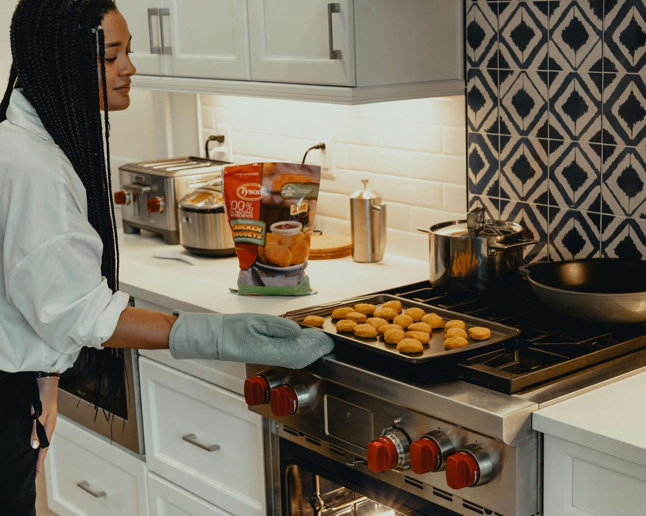 Women cooking food from Tyson food packet.