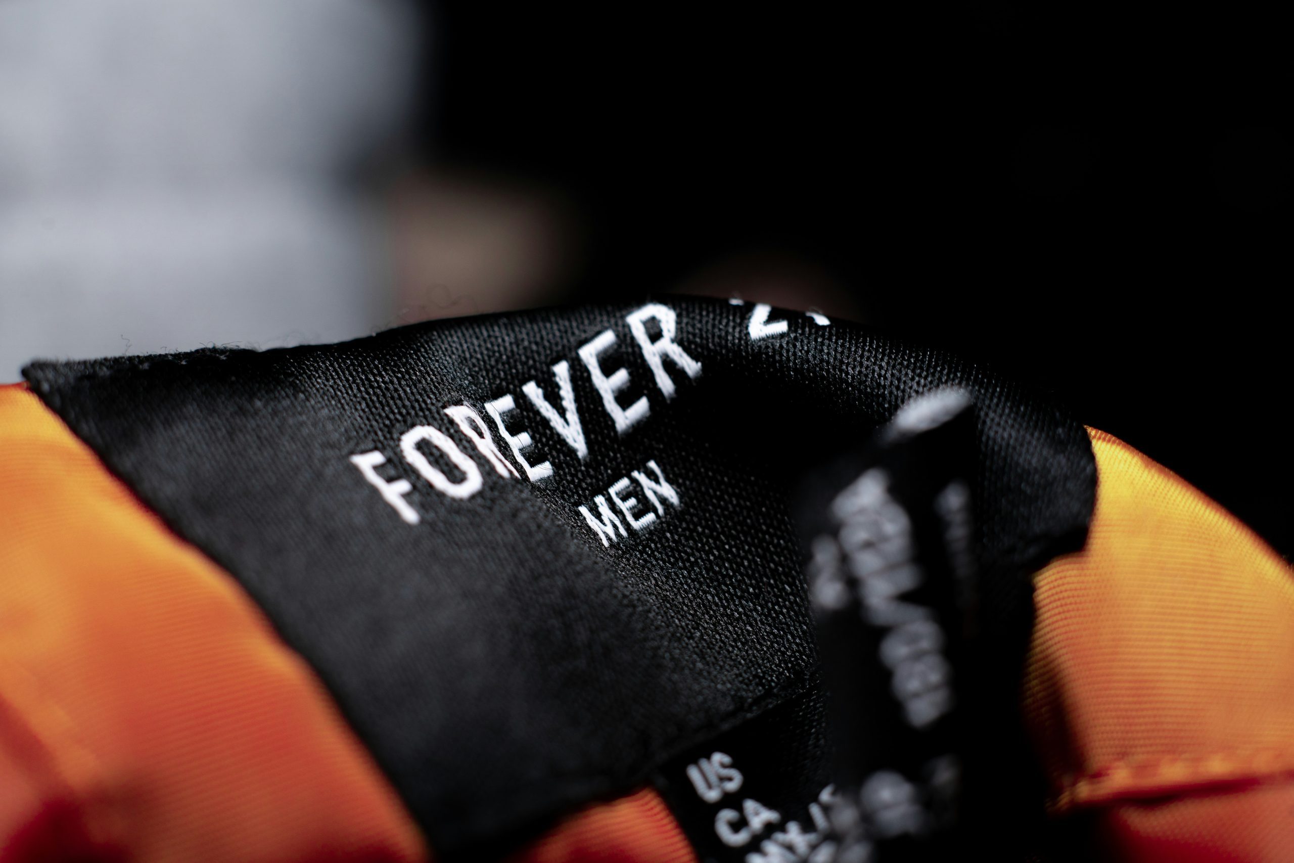 A forever 21 label on a man's coat.