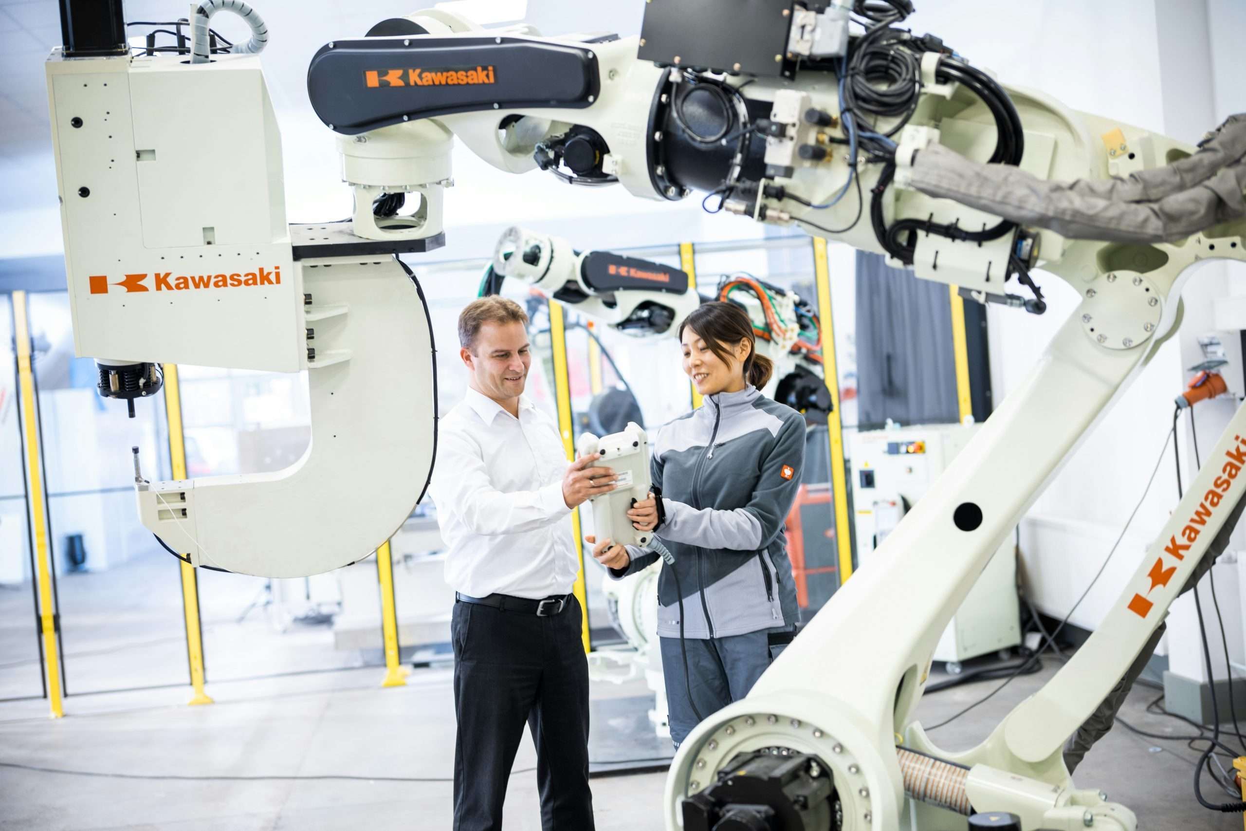 Two people working on the deployment of robotics in a lab.