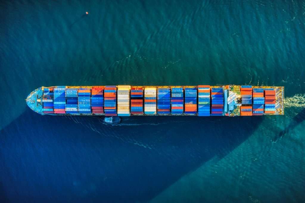 A birds eye view of a ship crossing the ocean.