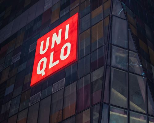 A uniqlo store front seen at night.