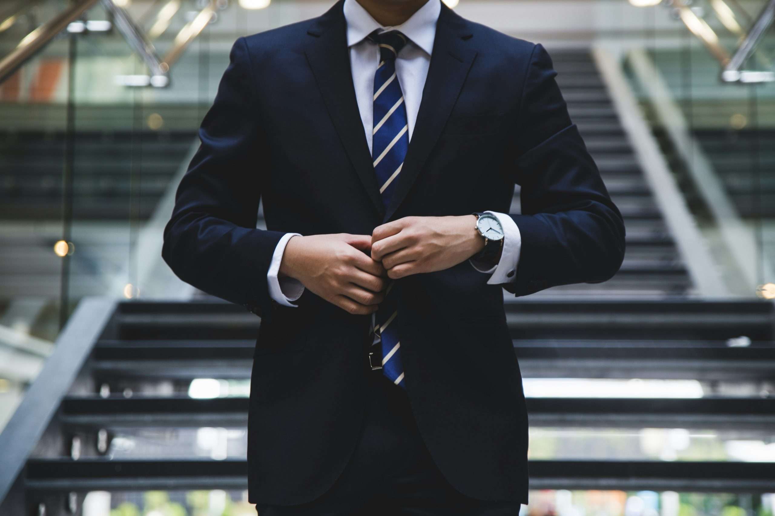 Interviewee fixing tie before job interview.