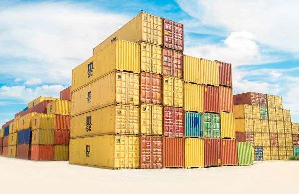 A stack of shipping containers in a shipping yard.