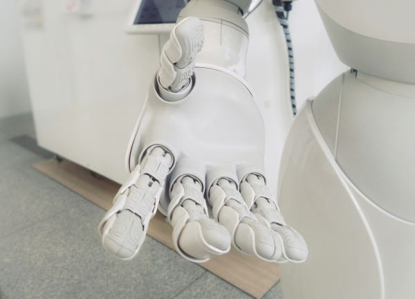 Robot hand reaching out representing AI.