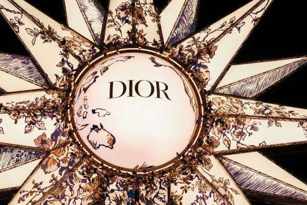 A large Dior logo as seen on perfume bottle.