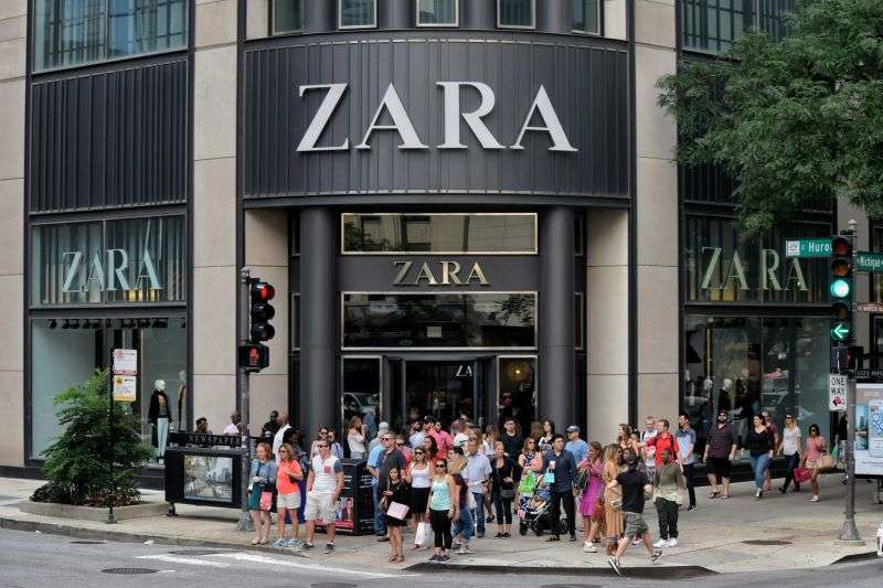 Shoppers queuing to enter a flagship Zara store.