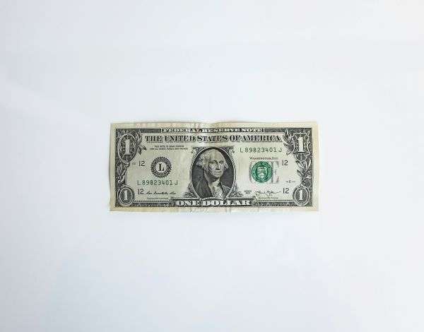 An old dollar bill set in front of a white background.