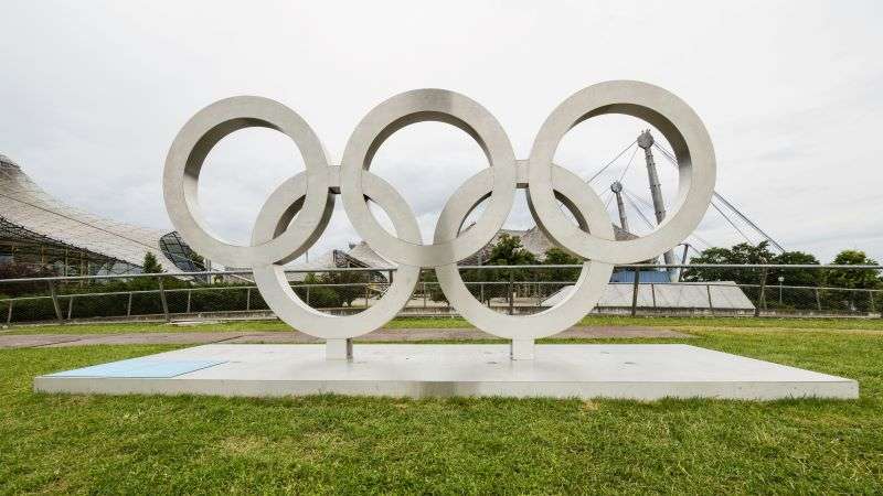 Galvanised steel olympic ring sculpture outside an olympic stadium.