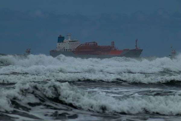 A ship navigating a large storm of the African Coastline.