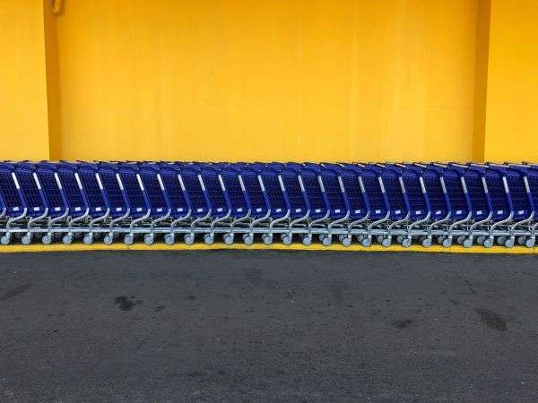 A line of walmart trollies parked outside a store