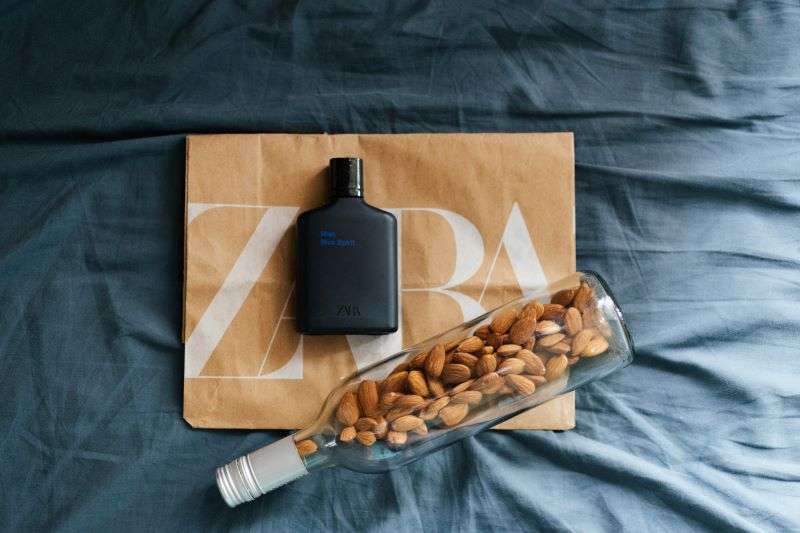 A selection of Zara products sitting on top of a brown Zara paper bag.