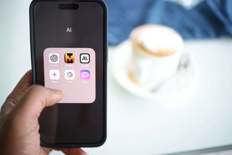 A person visiting the AI folder of Apps on their Smartphone. Webgility have beta launched Webgility AI Assistant, an AI powered chat assistant.