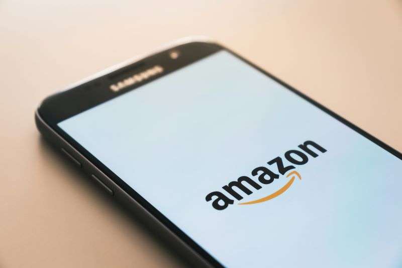 The Amazon logo displayed on a smartphone.