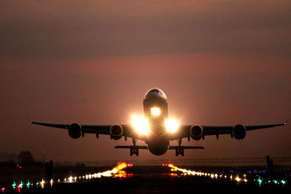 Air cargo coming into an airport runway on a night time flight. In July, a global IT outage resulted in more than a week's worth of flight delays and cancellations.