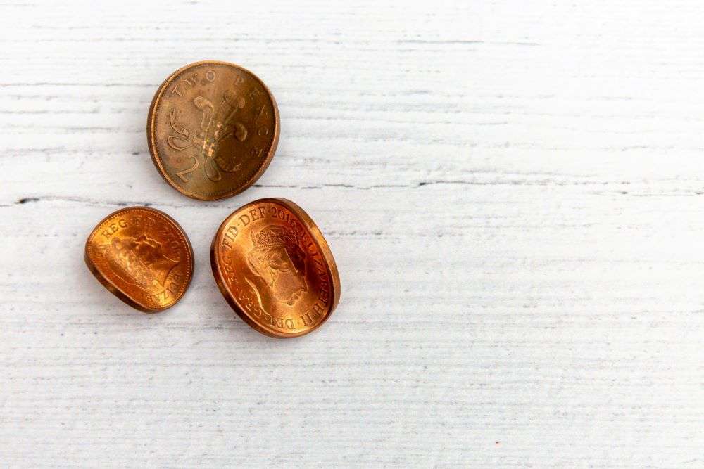 Bent copper coins representing corruption.