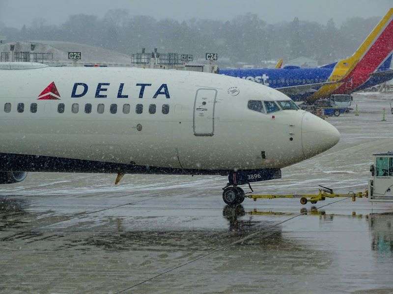 A Delta Airlines plane on the runway in the rain. CrowdStrike have recently accused Delta CEO of ignoring help during outage.