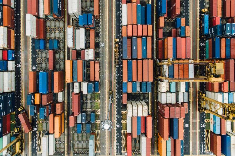 Shipping containers queued awaiting shipping. Over the past year, transit times, a critical metric for smooth operations, have seen a significant increase across key global trade routes.