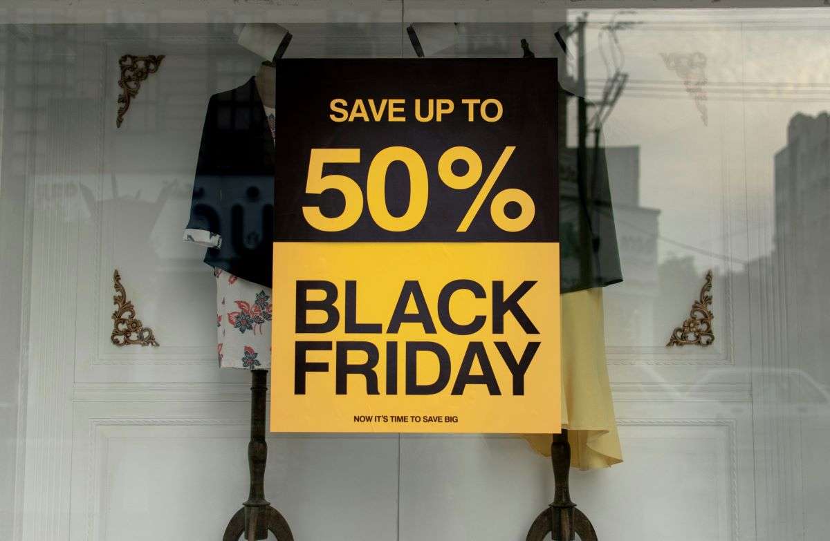 Black Friday signage outside shop. With £96 billion at stake, retailers are enhancing omnichannel strategies to optimize holiday season fulfillment.