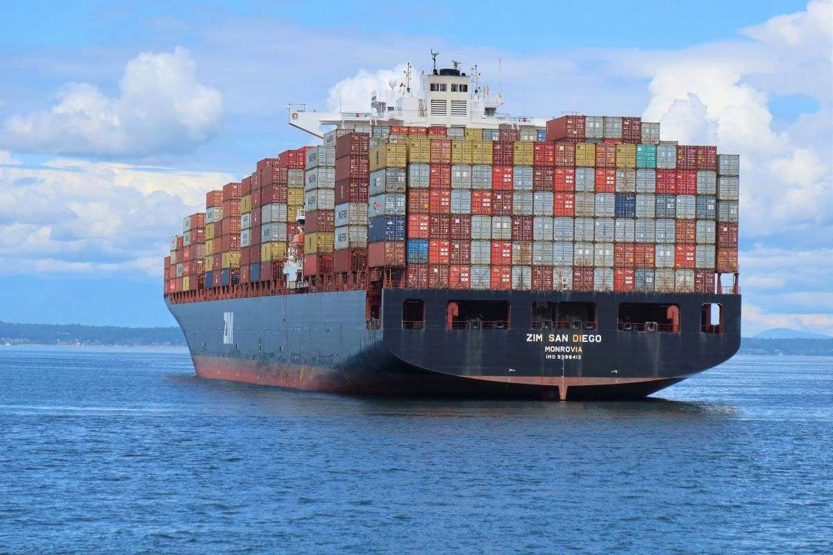 Ship carrying containers. WTO reports recovery in global merchandise trade, warns of uncertain economic outlook.